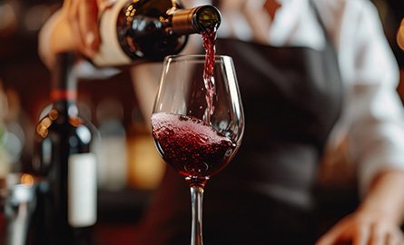 A server with a glass out wine